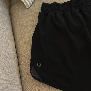 Lulu Lemon black shorts, sz 6, tall, small paint stain on back, small pocket.